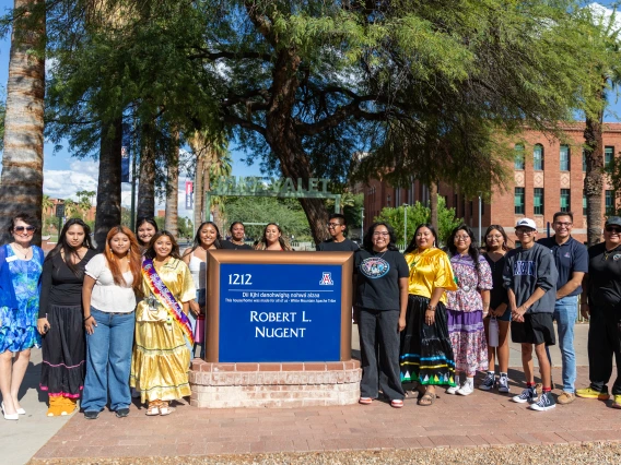 Members of the White Mountain Apache Tribe with the Nugent Building Sign
