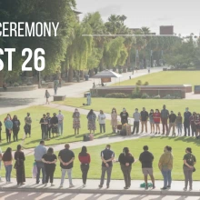 Students, staff, faculty, and community members standing in a circle